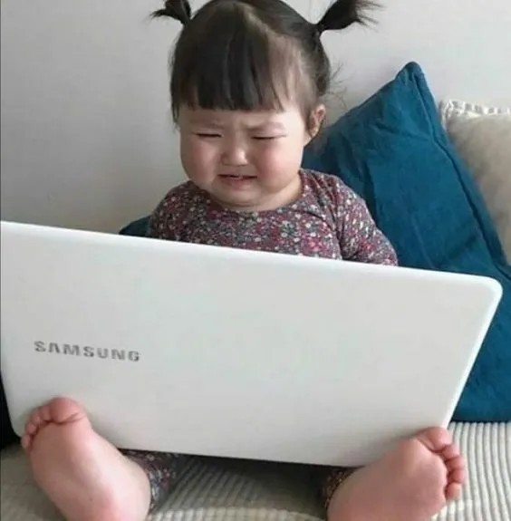 Ảnh cô bé mếu máo dùng máy tính đáng yêu, phù hợp sử dụng trong các tình huống phải chạy deadline
